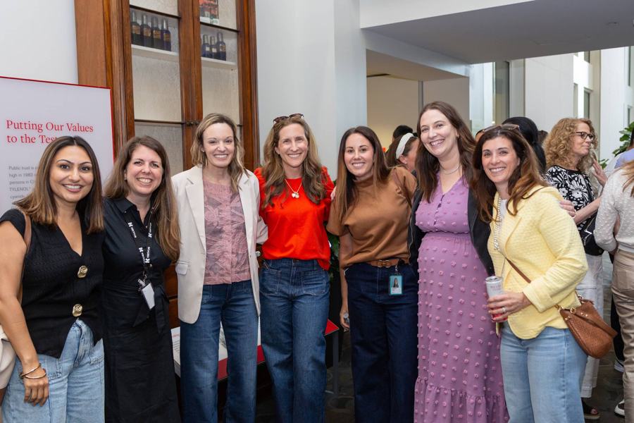 Colleagues smiling together at an evening event